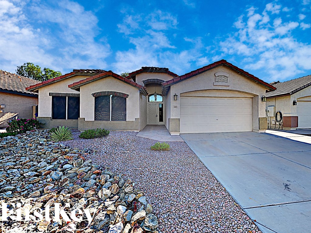 A house with a driveway and garage is for sale.