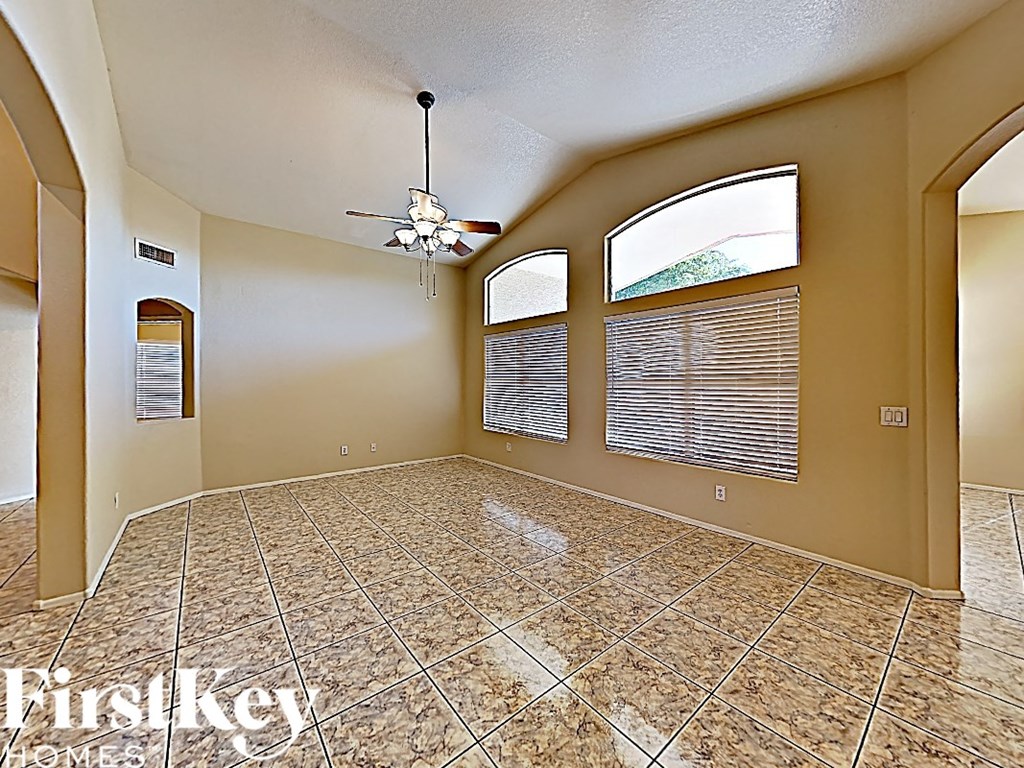 A room with a tiled floor and a ceiling fan.