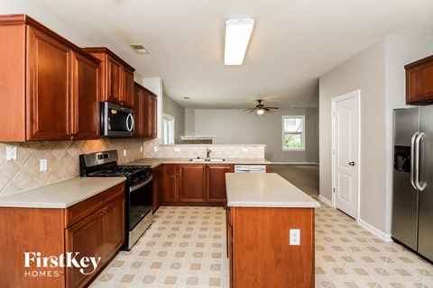 a kitchen with wooden cabinets and stainless steel appliances