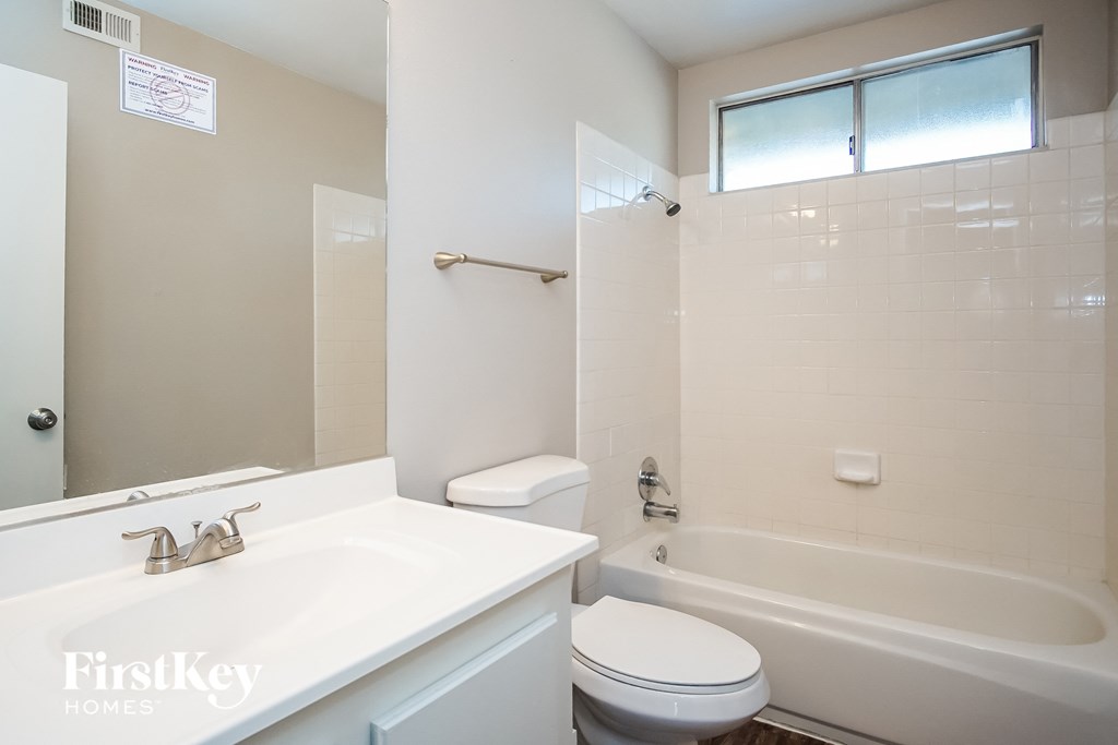a bathroom with a sink toilet and a bath tub