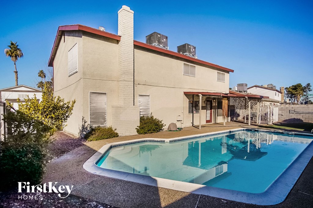 a house with a pool in front of it