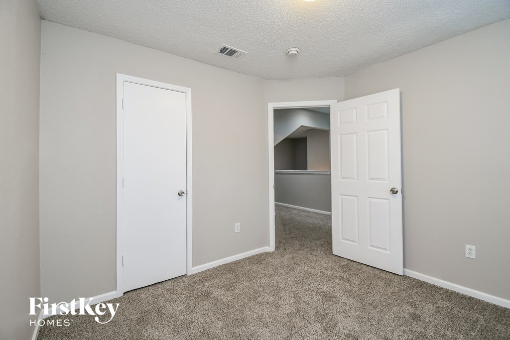 a bedroom with a closet and an open door