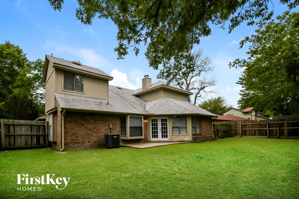 a house with a yard and a wood fence