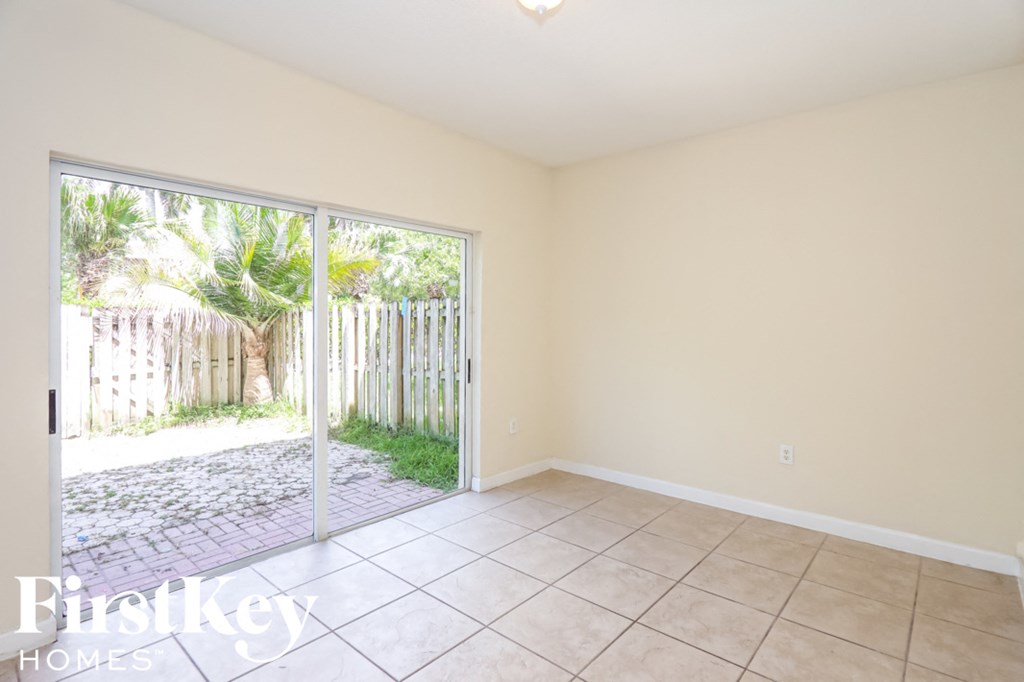 an empty living room with a sliding glass door to the patio