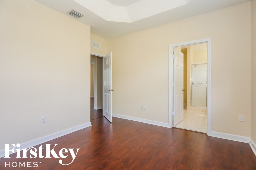 a empty room with wood floors and white walls