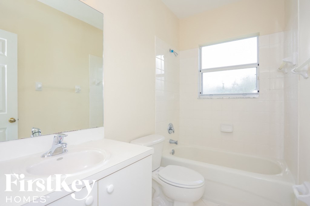 a white bathroom with a toilet sink and tub