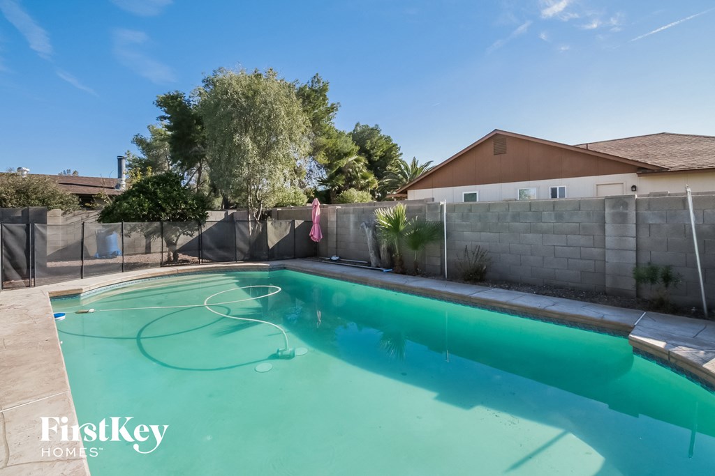 A swimming pool with a FirstKey Homes logo.