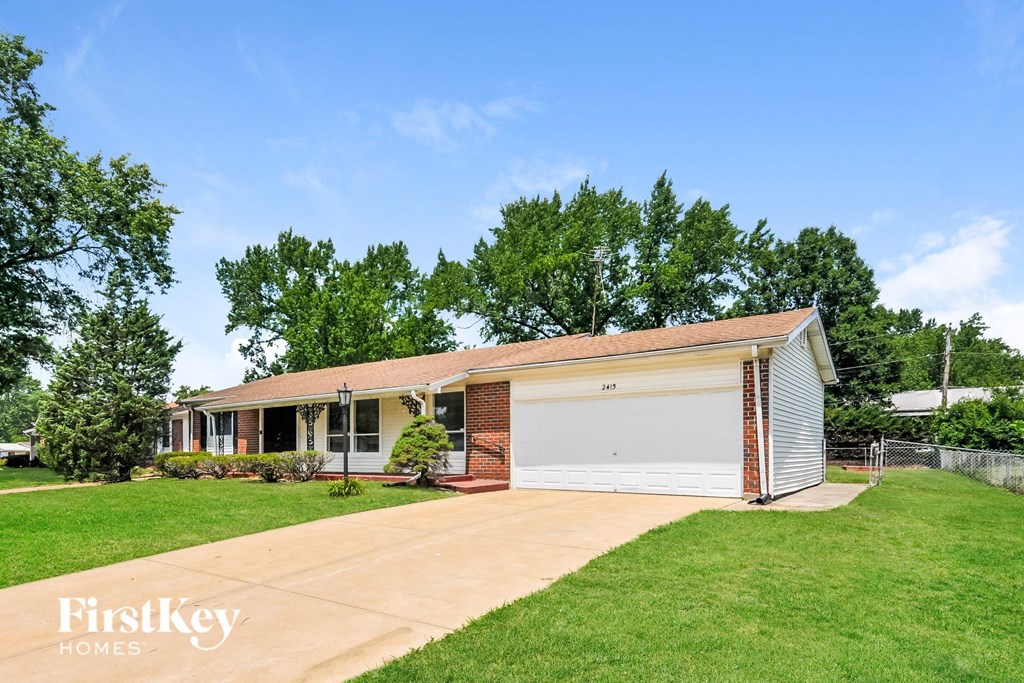 a small brick house with a white garage door