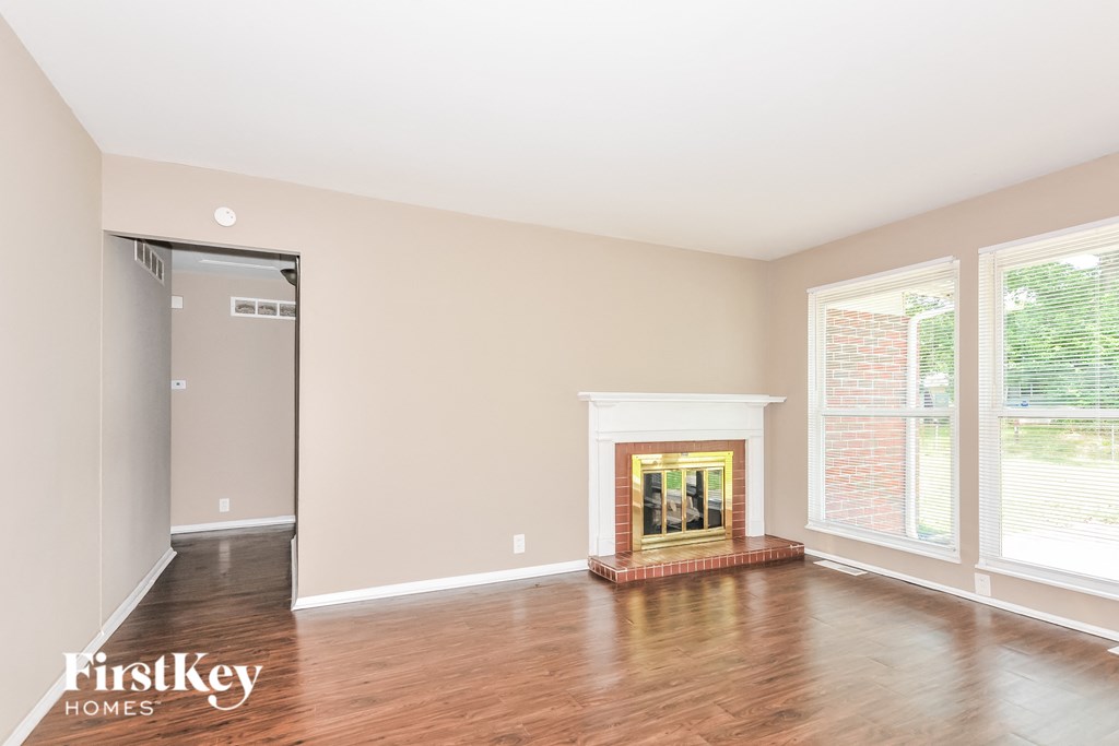 a living room with wood floors and a fireplace