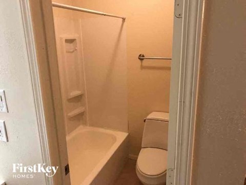 a small bathroom with a toilet and a tub