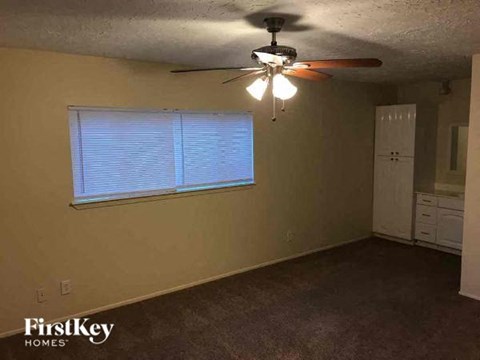 a living room with a ceiling fan and a window