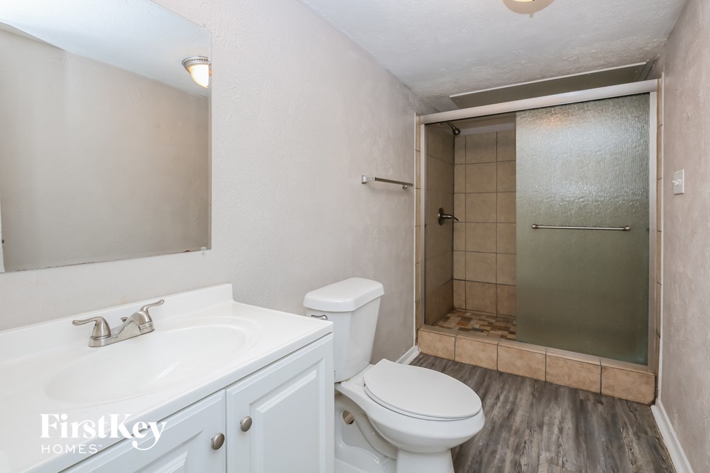 a bathroom with a toilet sink and a shower