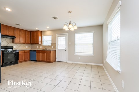 A kitchen with wooden cabinets and a black oven.