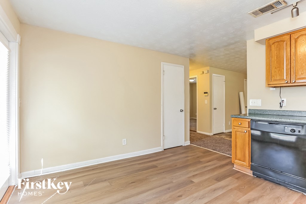 A kitchen with wooden cabinets and a black stove top oven.