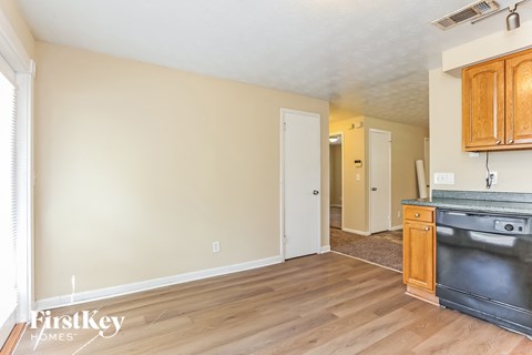 A kitchen with wooden cabinets and a black stove top oven.