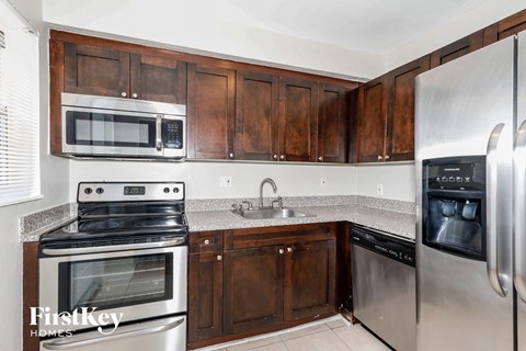 A kitchen with wooden cabinets and stainless steel appliances.