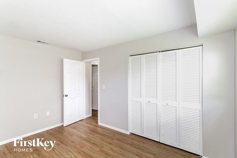 a bedroom with two closets and a door to a hallway