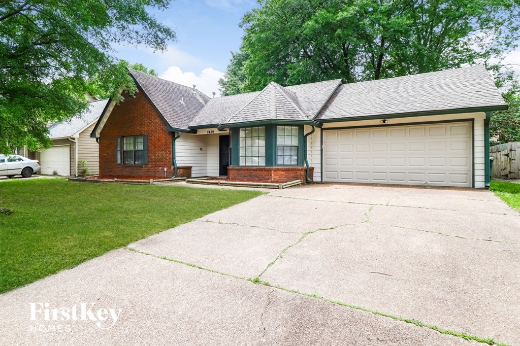 a house with a driveway and a white garage door