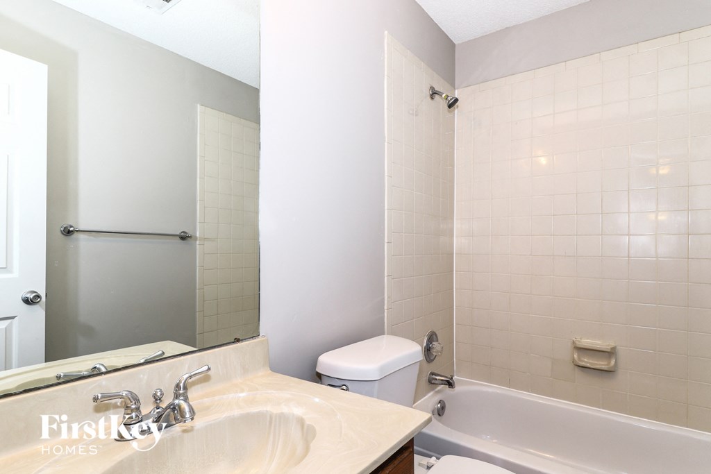 a bathroom with a sink and a toilet and a bath tub