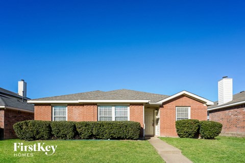 a house with a yard and a blue sky
