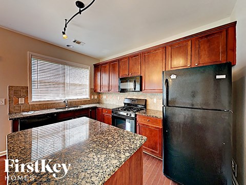a kitchen with black appliances and granite counter tops