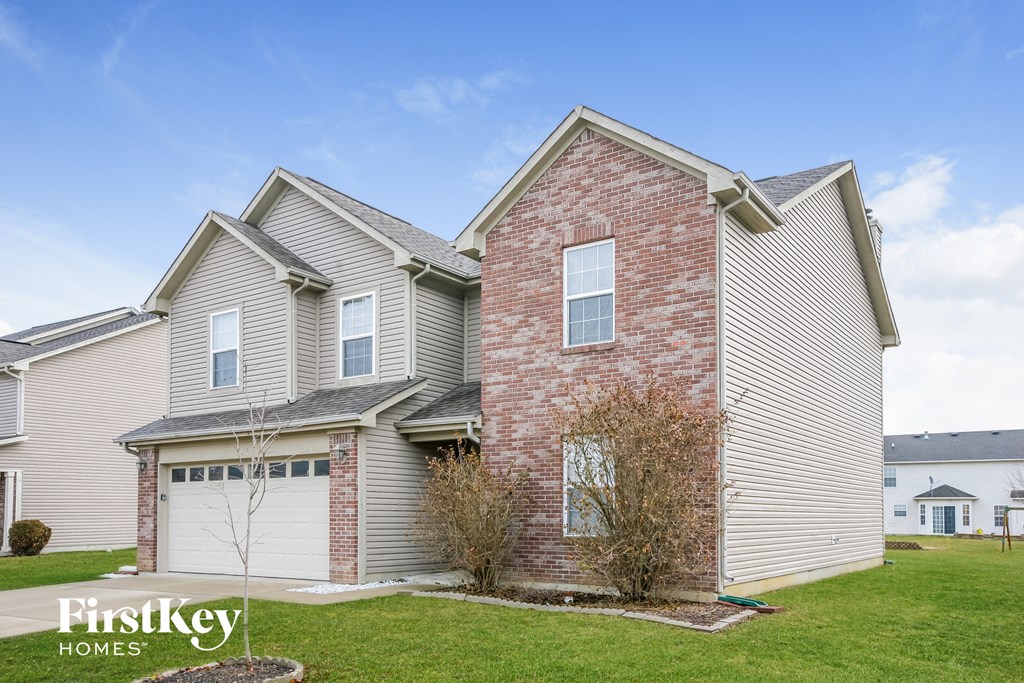 A house with a brick chimney and a garage door.