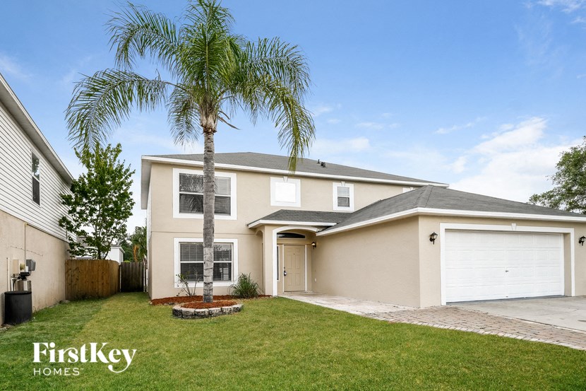 a house with a palm tree in front of it