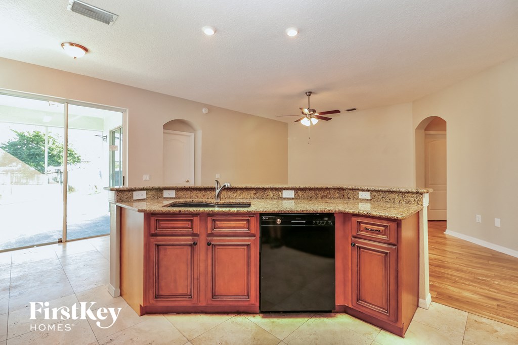a kitchen with wooden cabinets and a counter top and a sink