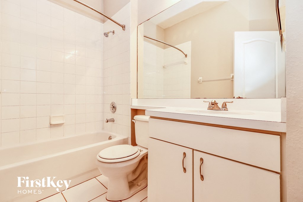 a bathroom with a toilet and a sink and a tub
