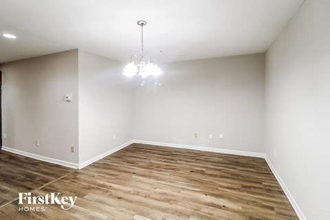 a living room with wood flooring and white walls
