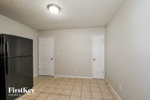 a kitchen with a refrigerator and a white door