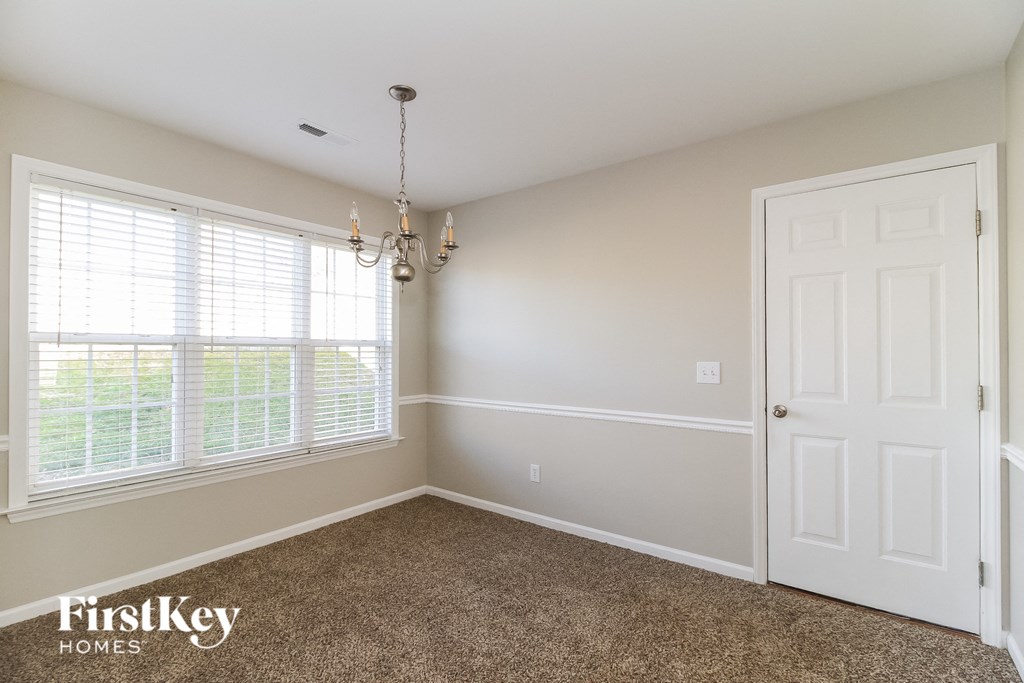 a bedroom with a large window and a white door