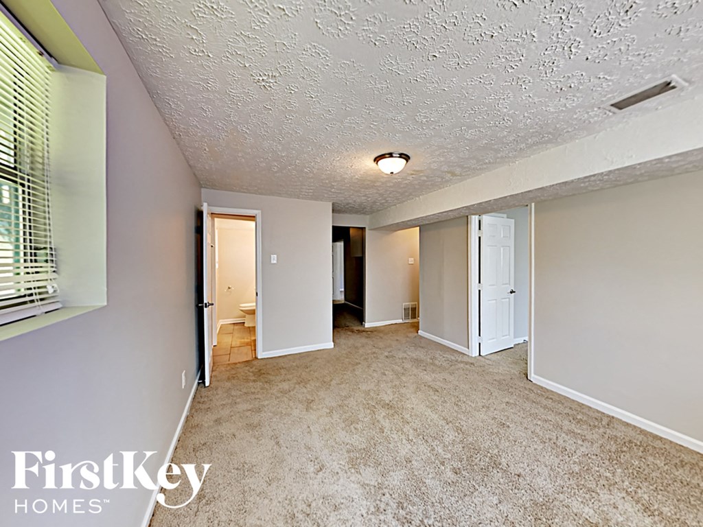 the living room and dining room of an empty house
