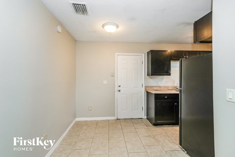a small kitchen with a refrigerator and a sink