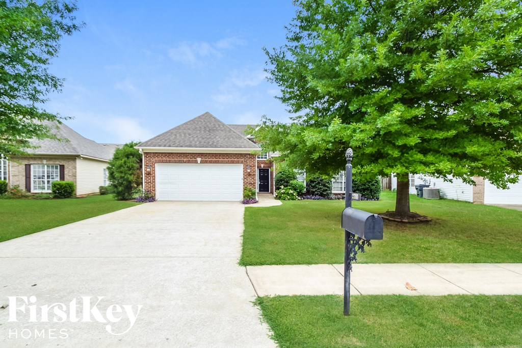a house with a driveway and a parking meter in front of it