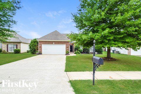 a house with a driveway and a parking meter in front of it