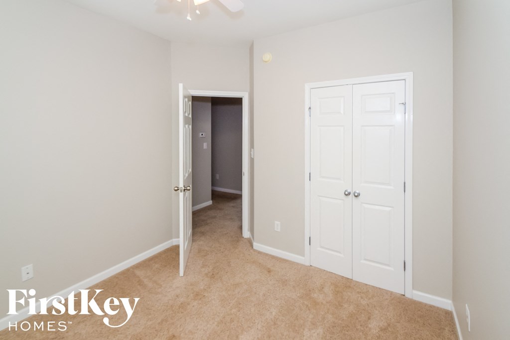 a bedroom with two closets and a hallway with a door to a closet