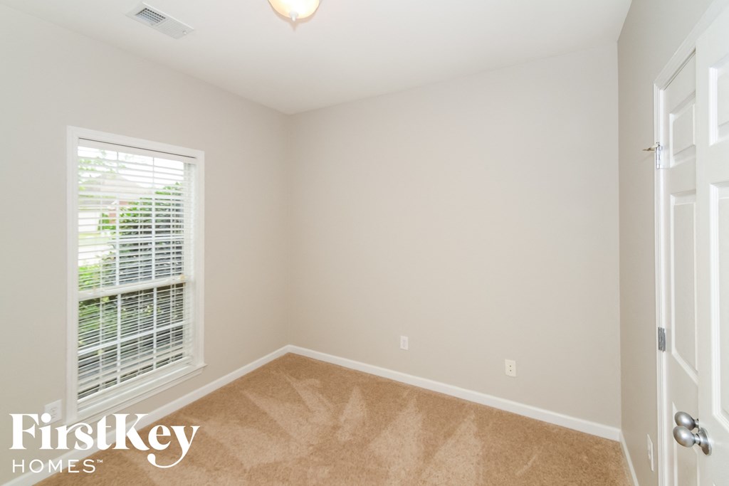 a empty room with a window and a door