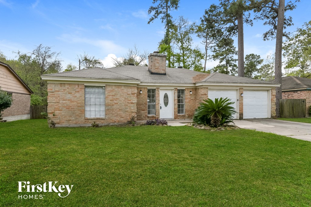 a brick house with a lawn and a white garage door
