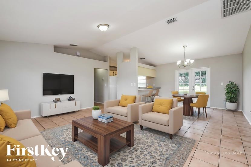 A living room with a wooden coffee table and yellow cushions.