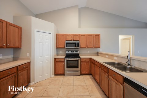 a kitchen with wooden cabinets and stainless steel appliances