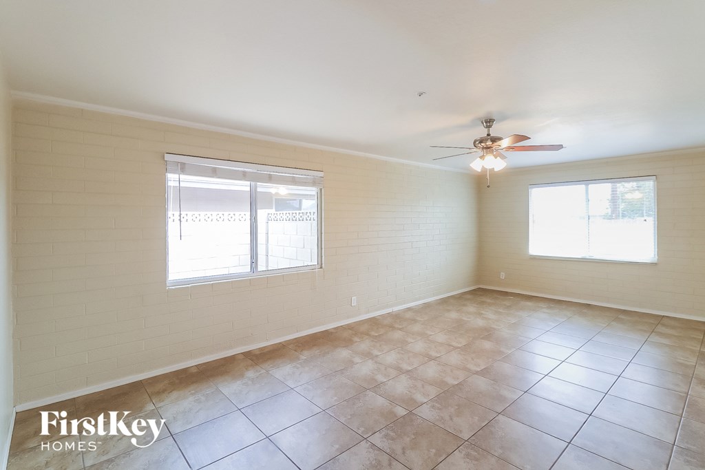 a living room with tiled floors and a ceiling fan