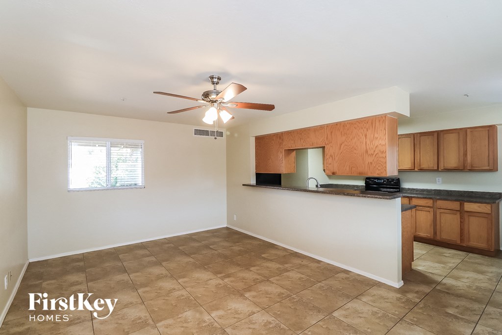 a kitchen with a counter top and a ceiling fan