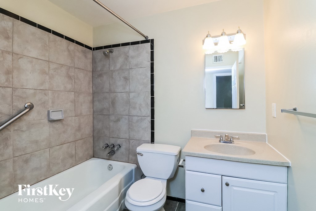 a bathroom with a sink toilet and a tub