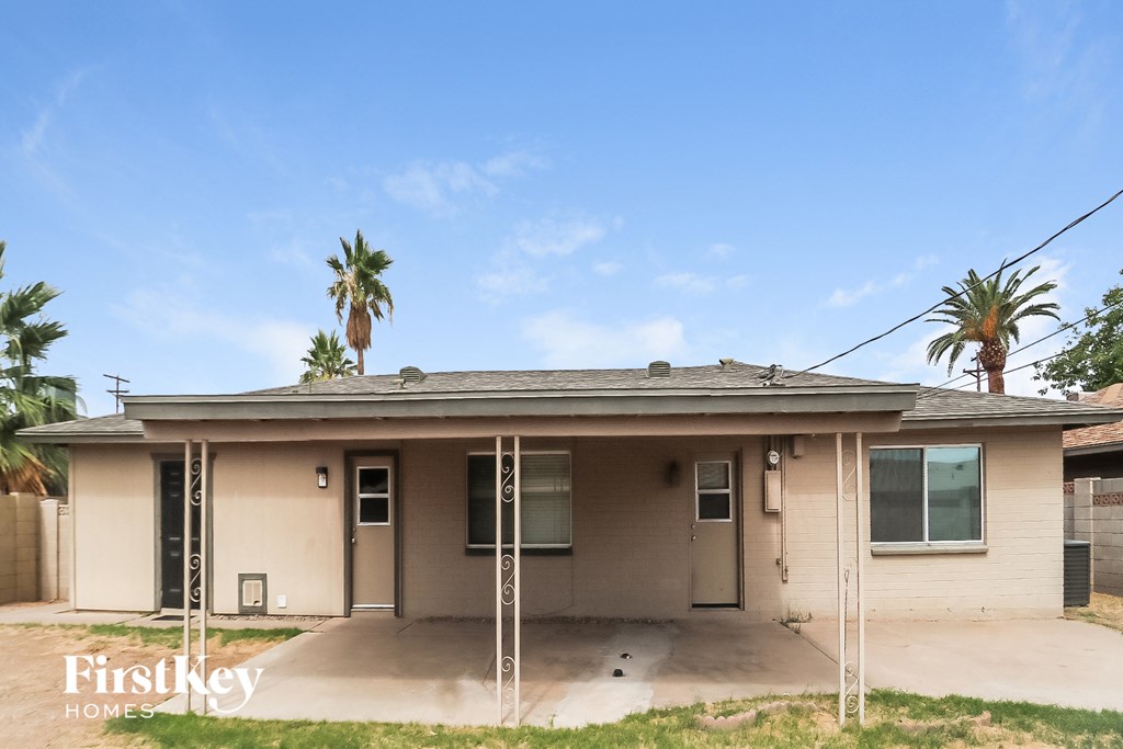 a small house with palm trees in the background