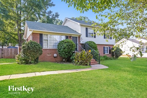 A house with a lawn in front of it.