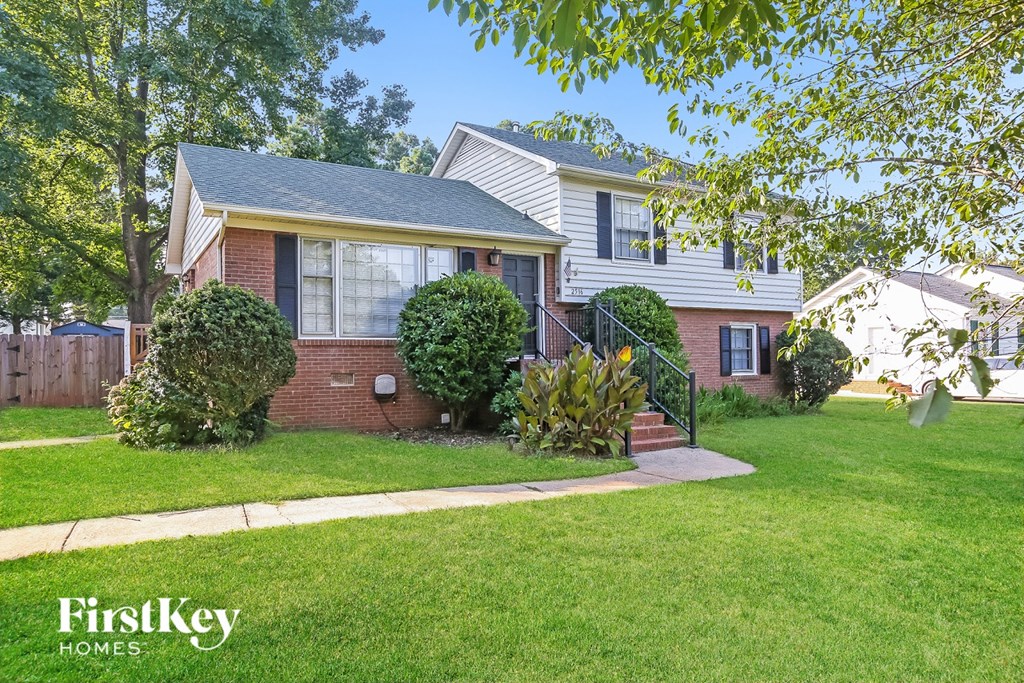 A house with a lawn in front of it.