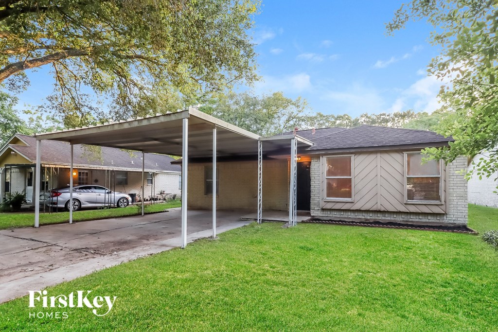 A house with a carport attached to it.