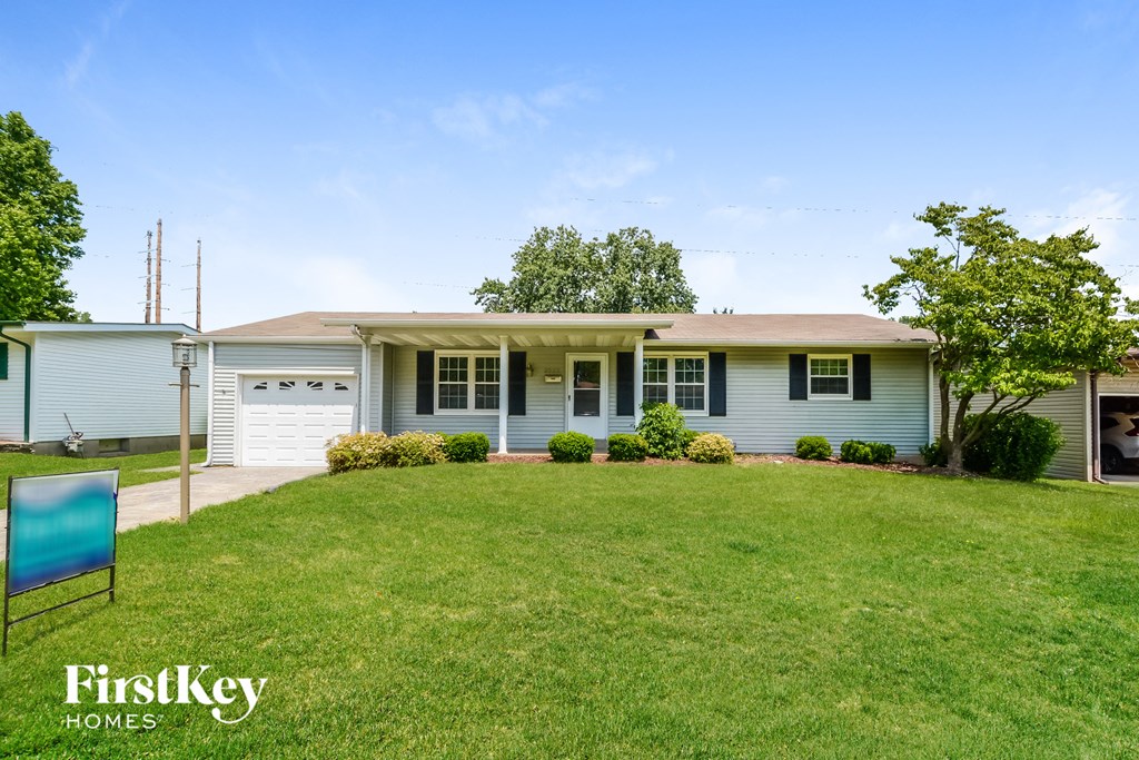 A house with a lawn in front of it and a sign that says FirstKey Homes.