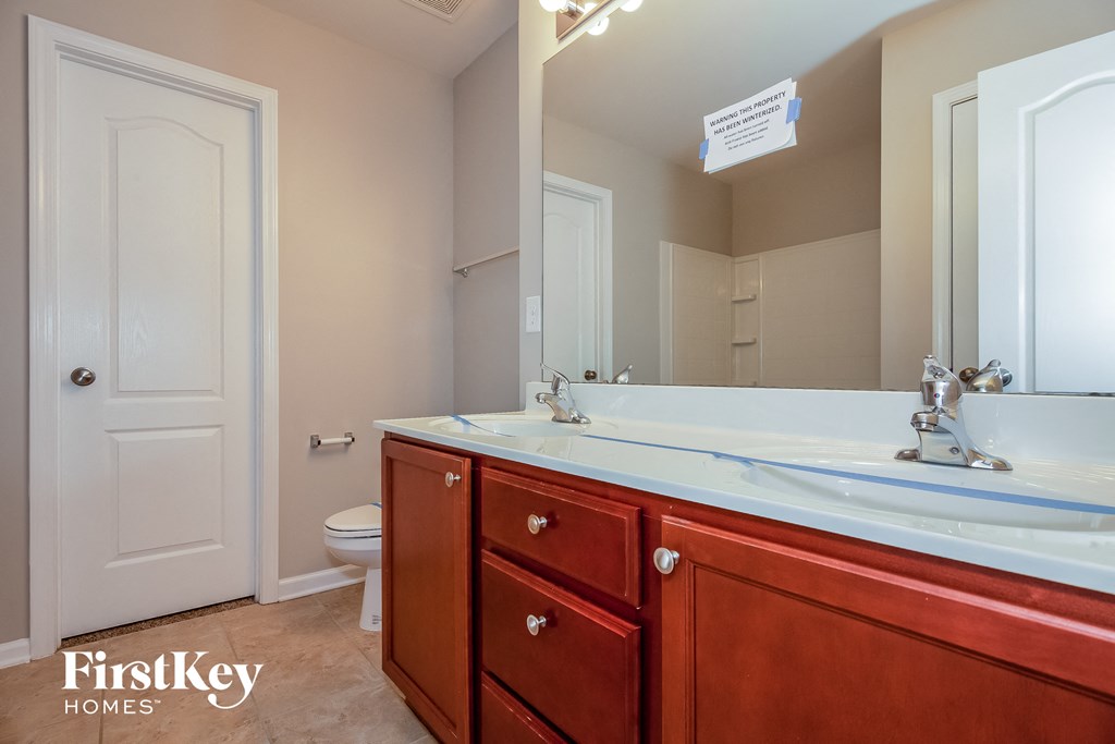 a bathroom with a sink and a mirror and a toilet